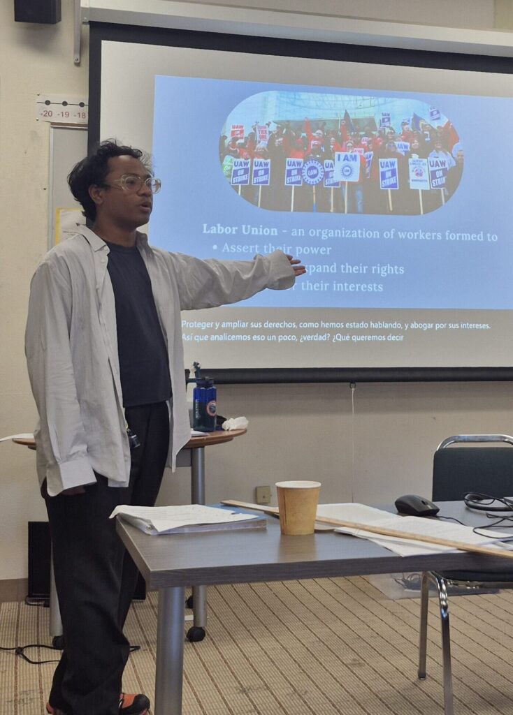 Instructor presenting a slideshow about labor unions to a classroom