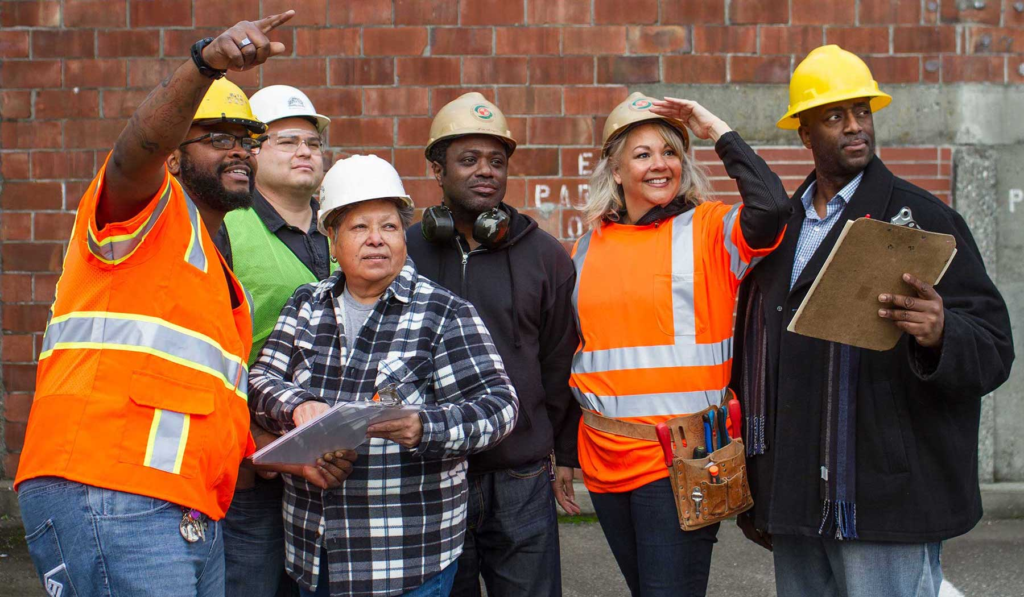 Group of workers in hard hats and safety vests at a construction site
