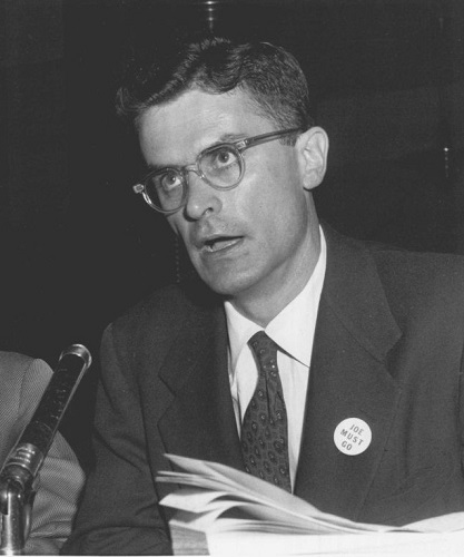 Black and white photo of Will Parry speaking into a microphone, 1954